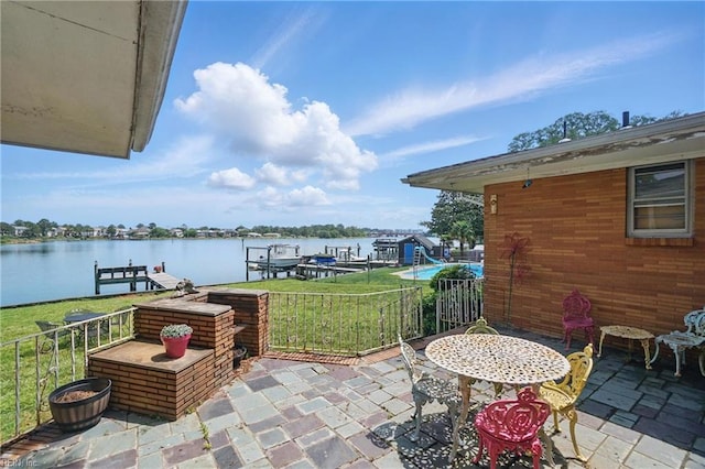 view of patio featuring a water view and a boat dock