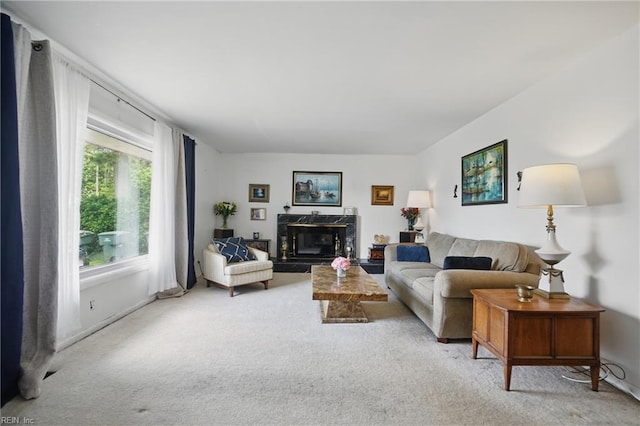 living area featuring carpet, a fireplace, and baseboards