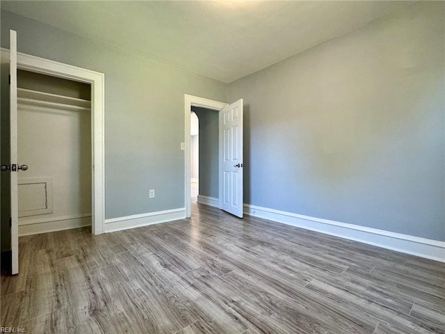 111 E Cummings Ave, Hampton, VA 23663 - unfurnished bedroom with wood finished floors, baseboards, arched walkways, and a closet