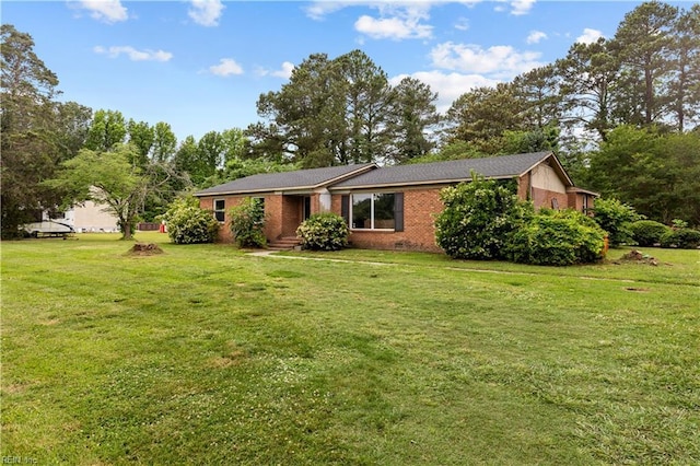 1607 Dellaire Dr, Elizabeth City, NC 27909 - view of front of home with a front yard, brick siding, and view of scattered trees