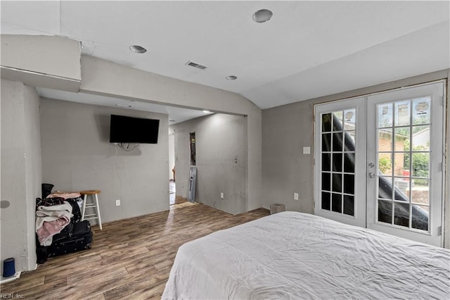 1607 Dellaire Dr, Elizabeth City, NC 27909 - bedroom featuring french doors, wood finished floors, lofted ceiling, and access to exterior