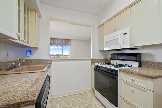 7320 Glenroie Ave Unit 8E, Norfolk, VA 23505 - kitchen featuring gas range oven, white microwave, a sink, dishwasher, and glass insert cabinets