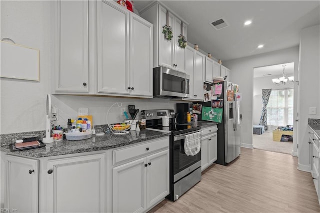 954 Olmstead St, Chesapeake, VA 23323 - kitchen featuring appliances with stainless steel finishes, a chandelier, light wood-style flooring, recessed lighting, and dark stone countertops