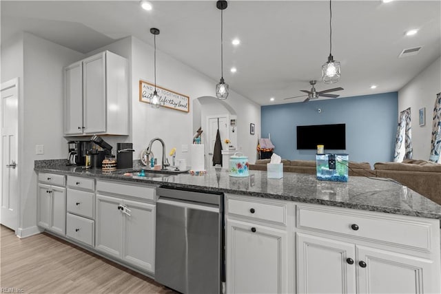 954 Olmstead St, Chesapeake, VA 23323 - kitchen with stainless steel dishwasher, a sink, a ceiling fan, arched walkways, and light wood-style flooring