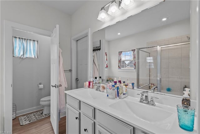 954 Olmstead St, Chesapeake, VA 23323 - bathroom featuring toilet, double vanity, wood finished floors, a tile shower, and baseboards