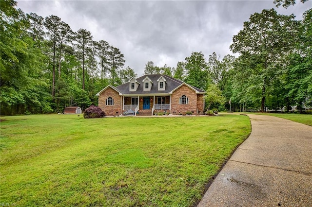 1813 Taft Rd, Chesapeake, VA 23322 - new england style home featuring covered porch, brick siding, and a front yard
