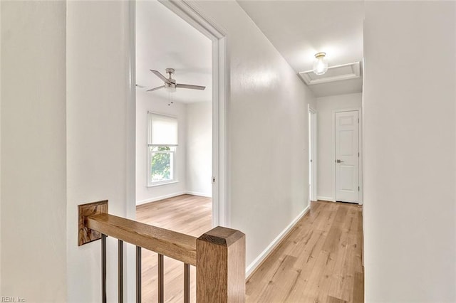 hallway with light wood-style floors and baseboards