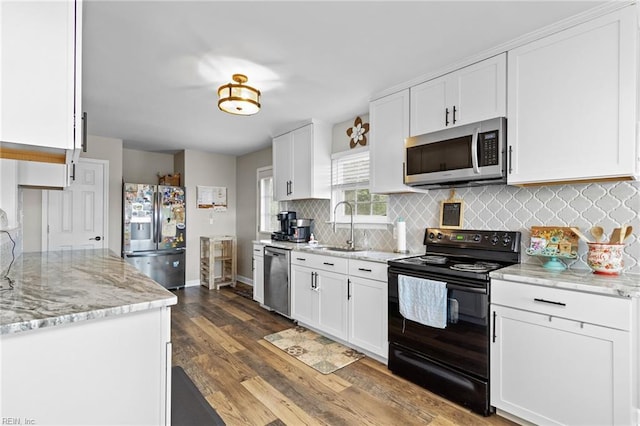 150 Ridge Rd, Poquoson, VA 23662 - kitchen with appliances with stainless steel finishes, dark wood finished floors, white cabinets, backsplash, and a sink