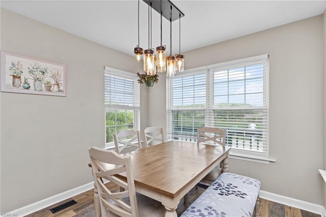 150 Ridge Rd, Poquoson, VA 23662 - dining space with baseboards, a chandelier, and wood finished floors