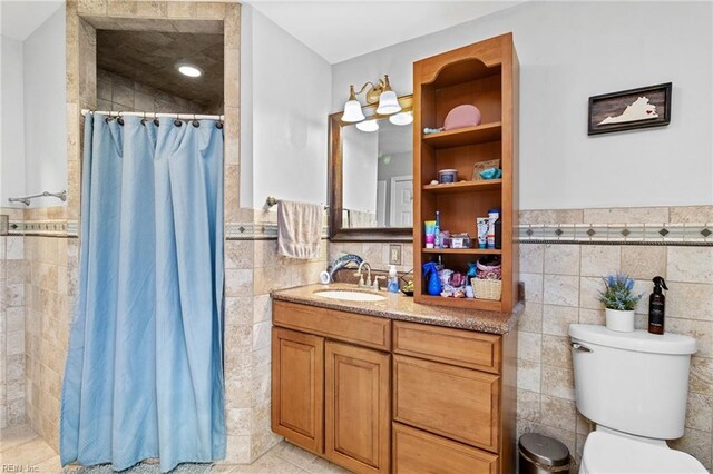 150 Ridge Rd, Poquoson, VA 23662 - full bath featuring tile walls, tiled shower, a wainscoted wall, vanity, and toilet