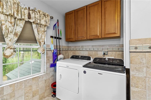 150 Ridge Rd, Poquoson, VA 23662 - laundry area featuring washer and dryer, tile walls, cabinet space, and wainscoting