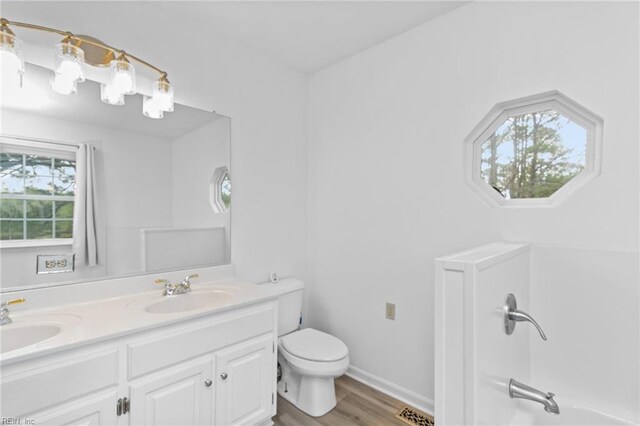 150 Ridge Rd, Poquoson, VA 23662 - full bathroom featuring toilet, wood finished floors, double vanity, and shower / bath combination