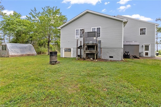 150 Ridge Rd, Poquoson, VA 23662 - rear view of property featuring an exterior structure, a yard, an outbuilding, and crawl space