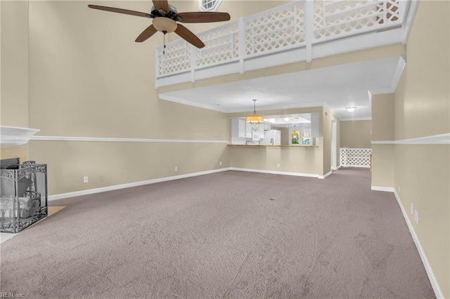 242 Genoa Dr Unit 20, Hampton, VA 23664 - unfurnished living room featuring carpet flooring, baseboards, ceiling fan, crown molding, and a high ceiling