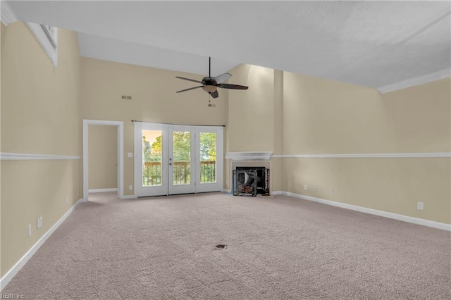242 Genoa Dr Unit 20, Hampton, VA 23664 - unfurnished living room featuring a ceiling fan, carpet floors, baseboards, a fireplace, and a high ceiling