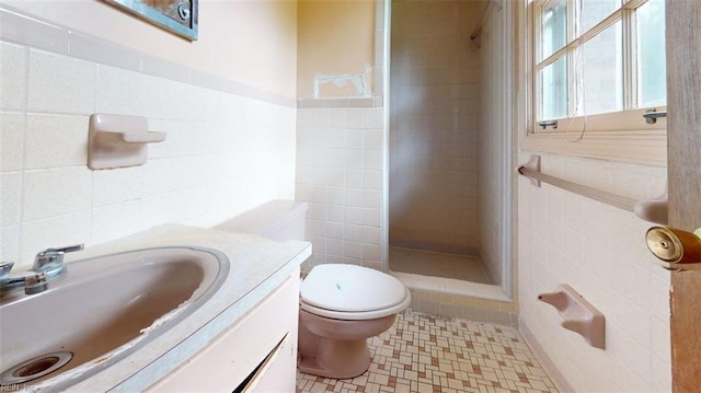 1030 Mary Peake Blvd, Hampton, VA 23666 - bathroom featuring tile walls, a stall shower, vanity, tile patterned floors, and toilet