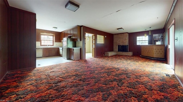 1030 Mary Peake Blvd, Hampton, VA 23666 - unfurnished living room with light carpet, a fireplace, and wooden walls