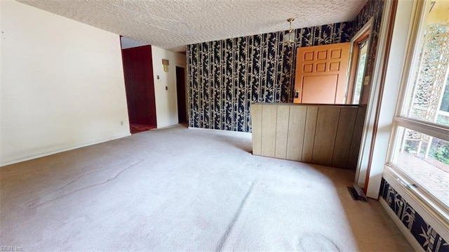 1030 Mary Peake Blvd, Hampton, VA 23666 - empty room featuring carpet, a textured ceiling, wallpapered walls, and baseboards
