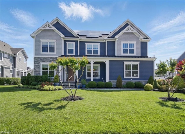 2244 Rio Rancho Dr, Virginia Beach, VA 23456 - craftsman-style home with a porch, solar panels, stone siding, and a front lawn