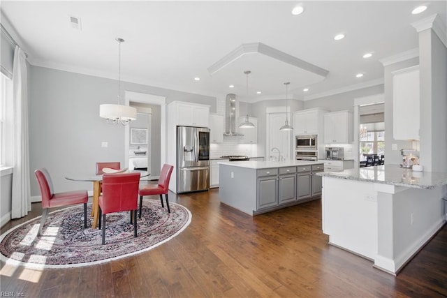 2244 Rio Rancho Dr, Virginia Beach, VA 23456 - kitchen with appliances with stainless steel finishes, wall chimney exhaust hood, ornamental molding, dark wood-style flooring, and decorative backsplash