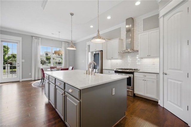 2244 Rio Rancho Dr, Virginia Beach, VA 23456 - kitchen featuring appliances with stainless steel finishes, wall chimney range hood, white cabinets, an island with sink, and recessed lighting