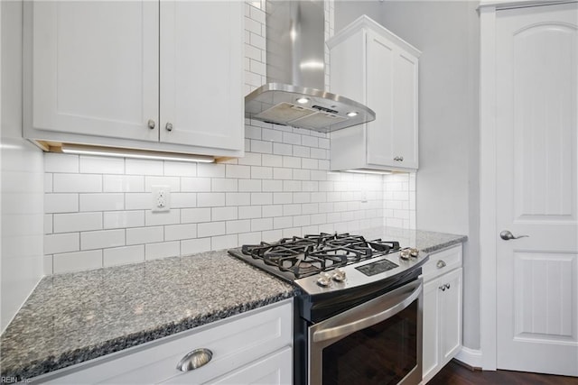 2244 Rio Rancho Dr, Virginia Beach, VA 23456 - kitchen with wall chimney exhaust hood, gas stove, dark stone counters, and white cabinets