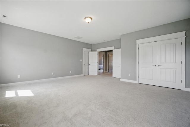 2244 Rio Rancho Dr, Virginia Beach, VA 23456 - unfurnished bedroom with light carpet, baseboards, and a closet