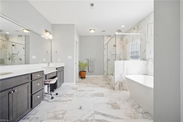 2244 Rio Rancho Dr, Virginia Beach, VA 23456 - bathroom with a marble finish shower, double vanity, a freestanding tub, marble tiled floors, and baseboards