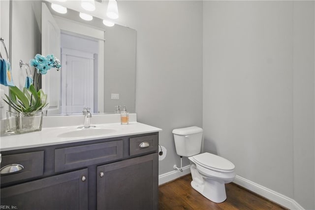 2244 Rio Rancho Dr, Virginia Beach, VA 23456 - half bathroom featuring wood finished floors, toilet, vanity, and baseboards