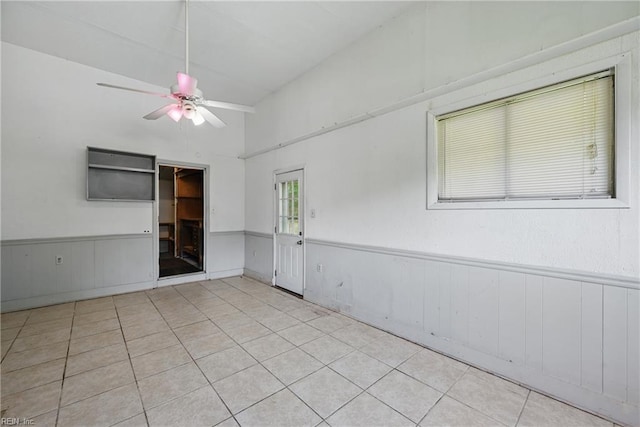 3813 Honeytree Ln, Virginia Beach, VA 23452 - empty room featuring a ceiling fan, wainscoting, tile patterned floors, and vaulted ceiling