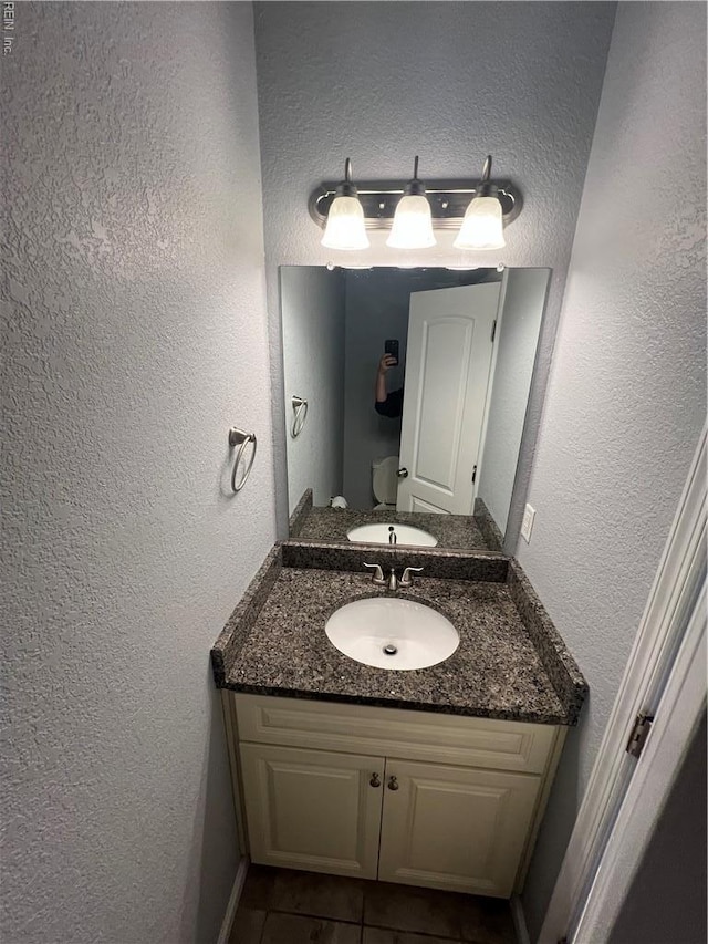 405 San Antonio Blvd, Norfolk, VA 23505 - half bath featuring a textured wall, vanity, and tile patterned flooring