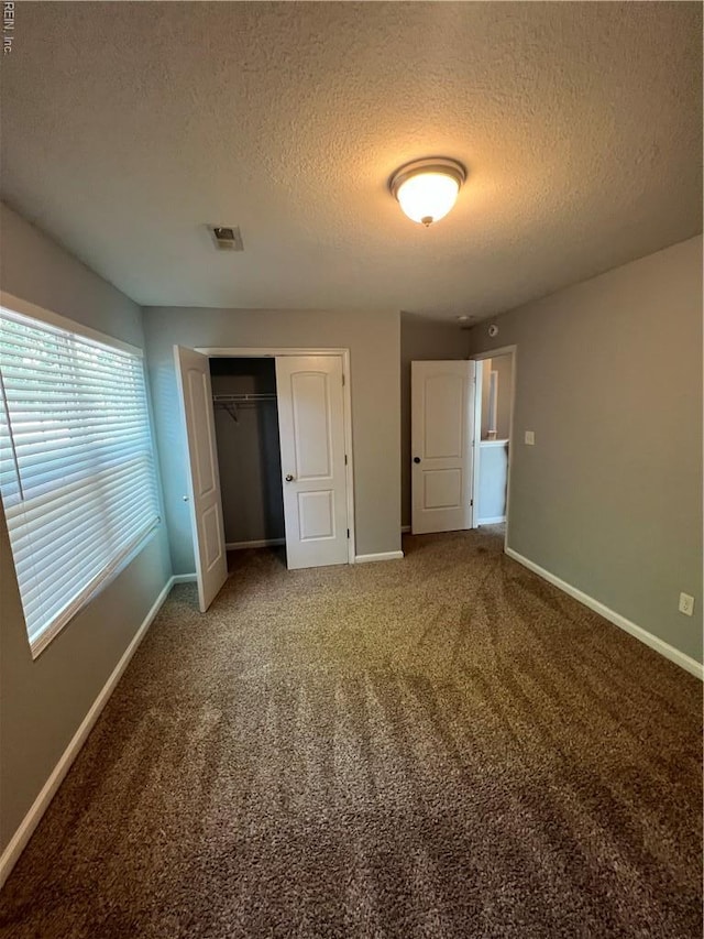 405 San Antonio Blvd, Norfolk, VA 23505 - unfurnished bedroom featuring baseboards, a textured ceiling, a closet, and carpet