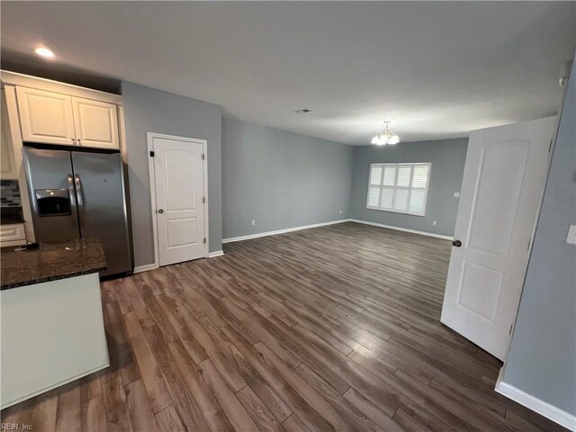 405 San Antonio Blvd, Norfolk, VA 23505 - kitchen with stainless steel fridge, baseboards, a chandelier, dark wood finished floors, and dark stone counters