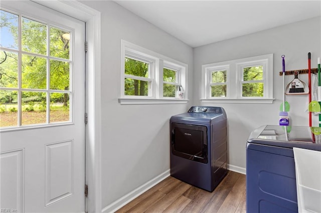 6944 Crittenden Rd, Suffolk, VA 23432 - clothes washing area with washer and clothes dryer, baseboards, wood finished floors, and healthy amount of natural light