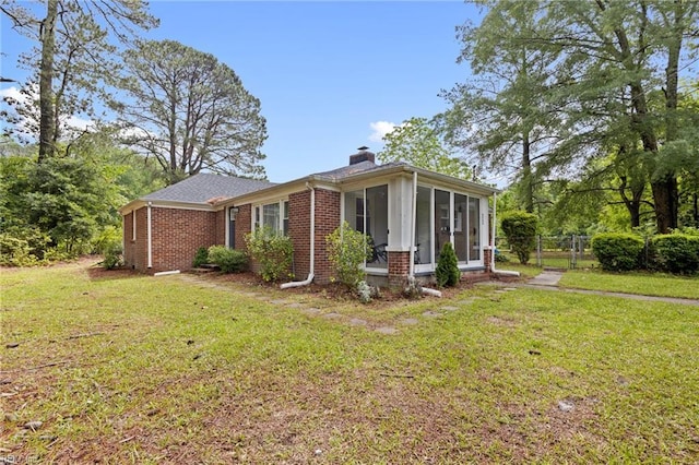 6944 Crittenden Rd, Suffolk, VA 23432 - view of front facade with brick siding, a chimney, and a sunroom