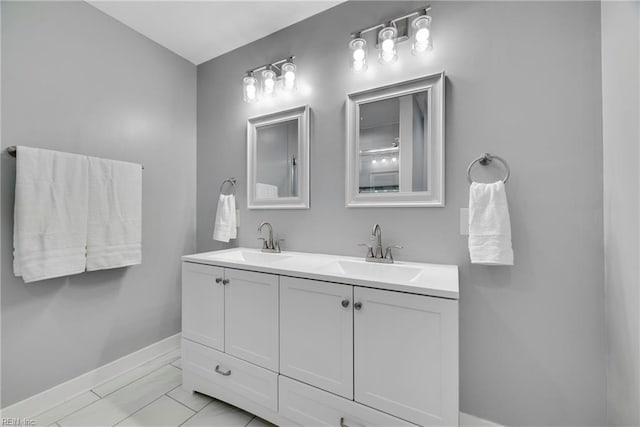 302 Artis St, Franklin, VA 23851 - bathroom with baseboards, marble finish flooring, and double vanity