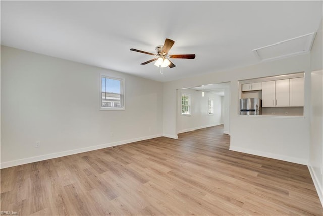 302 Artis St, Franklin, VA 23851 - unfurnished living room with light wood-type flooring, a ceiling fan, baseboards, and attic access
