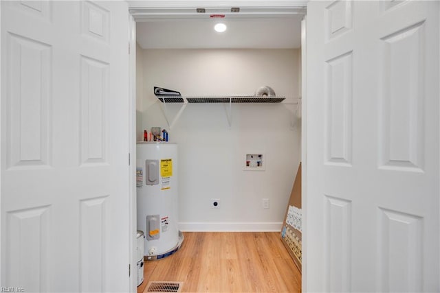 302 Artis St, Franklin, VA 23851 - clothes washing area with water heater, hookup for an electric dryer, hookup for a washing machine, light wood-type flooring, and recessed lighting