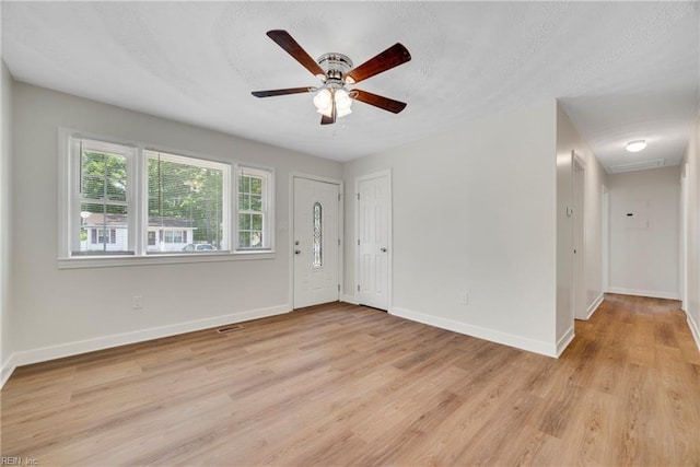 302 Artis St, Franklin, VA 23851 - foyer entrance with light wood finished floors, baseboards, ceiling fan, and a textured ceiling