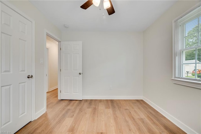 302 Artis St, Franklin, VA 23851 - unfurnished bedroom with multiple windows, baseboards, and light wood-style floors