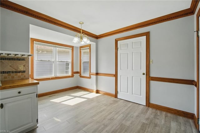 1121 Vineyard Dr, Chesapeake, VA 23322 - unfurnished dining area with a chandelier, baseboards, light wood-style floors, and ornamental molding