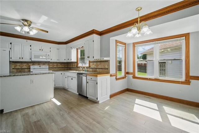 1121 Vineyard Dr, Chesapeake, VA 23322 - kitchen featuring white microwave, stainless steel dishwasher, stove, white cabinetry, and ornamental molding