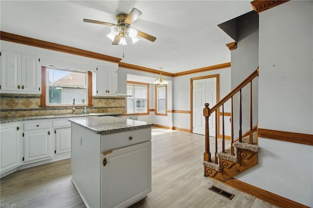 1121 Vineyard Dr, Chesapeake, VA 23322 - kitchen with a sink, tasteful backsplash, baseboards, ceiling fan, and white cabinetry