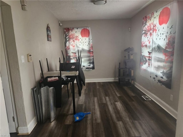 106 Clyde St, Hampton, VA 23669 - dining space with a wood stove, wood finished floors, a textured ceiling, and baseboards