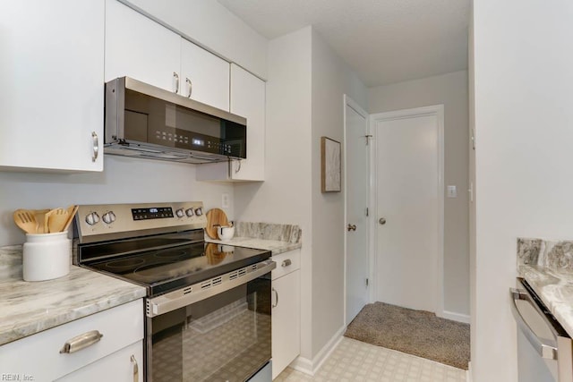 3857 Lasalle Dr Unit 102, Virginia Beach, VA 23453 - kitchen with appliances with stainless steel finishes, light flooring, white cabinetry, baseboards, and light stone counters