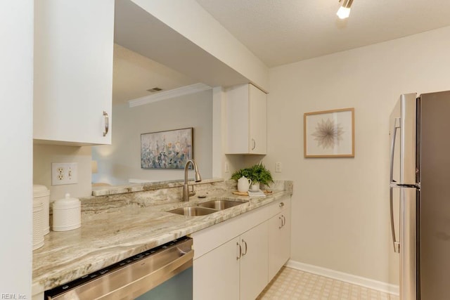 3857 Lasalle Dr Unit 102, Virginia Beach, VA 23453 - kitchen with stainless steel appliances, a sink, light stone counters, white cabinetry, and baseboards