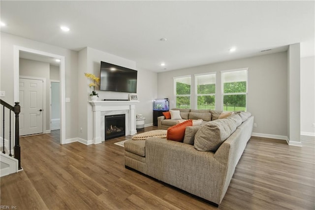 1028 Egret Ln, Suffolk, VA 23434 - living area with wood finished floors, stairway, baseboards, and recessed lighting