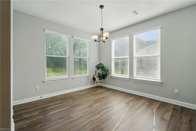 1028 Egret Ln, Suffolk, VA 23434 - unfurnished dining area featuring a chandelier, wood finished floors, and baseboards