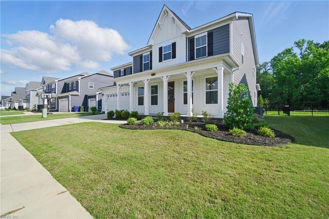 1028 Egret Ln, Suffolk, VA 23434 - view of front of house with board and batten siding, driveway, covered porch, a garage, and a residential view