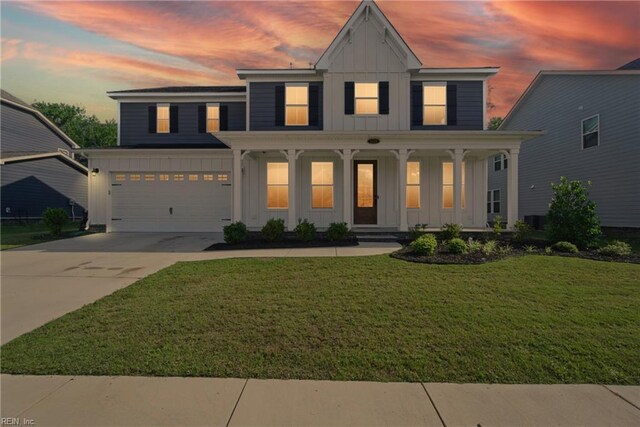 1028 Egret Ln, Suffolk, VA 23434 - modern farmhouse featuring board and batten siding, driveway, covered porch, a garage, and a lawn